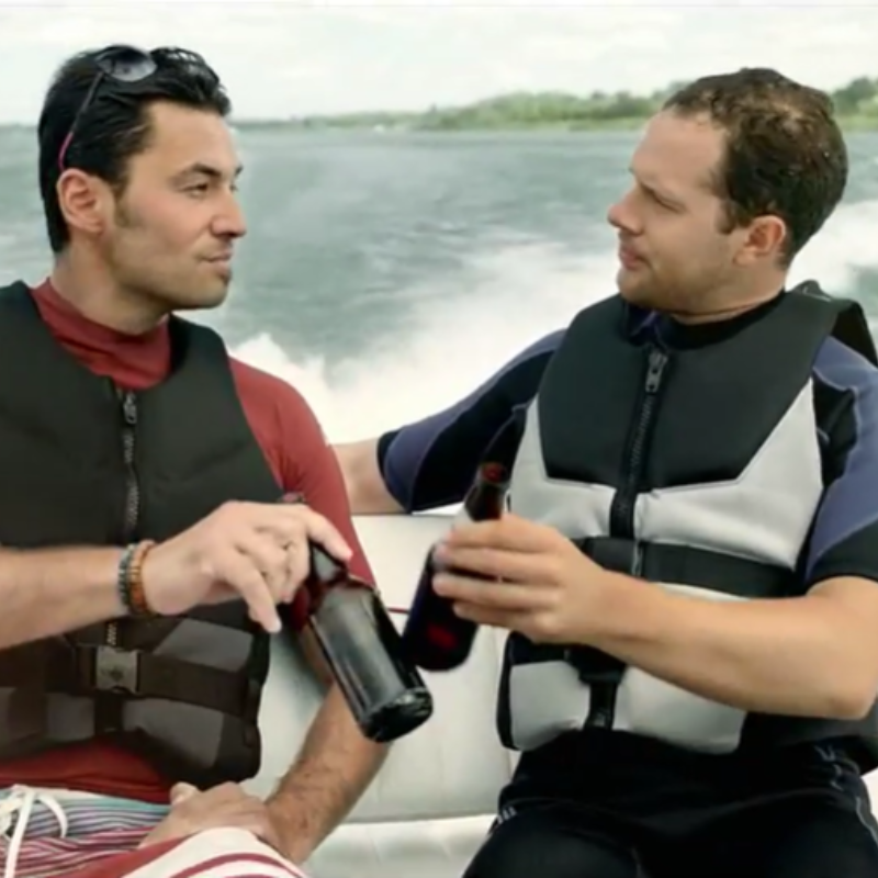 2 men having a beer on a boat